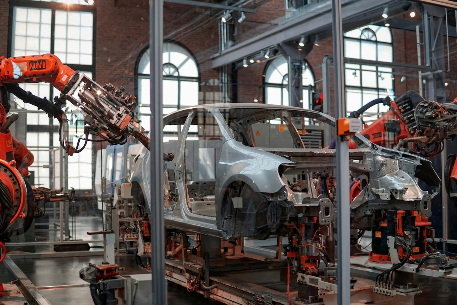 Robotic arms assembling a vehicle body on a factory line